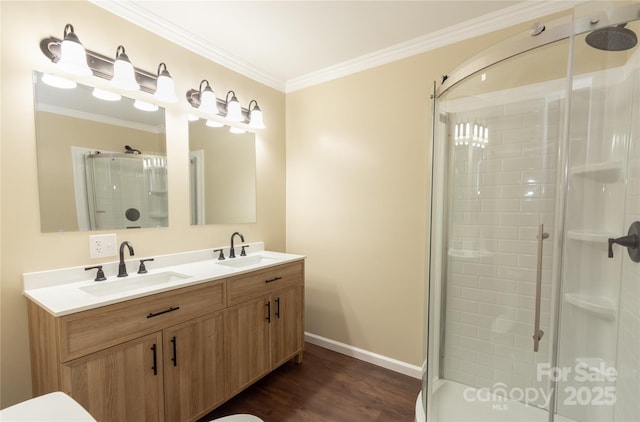 bathroom featuring vanity, hardwood / wood-style floors, crown molding, and a shower with shower door