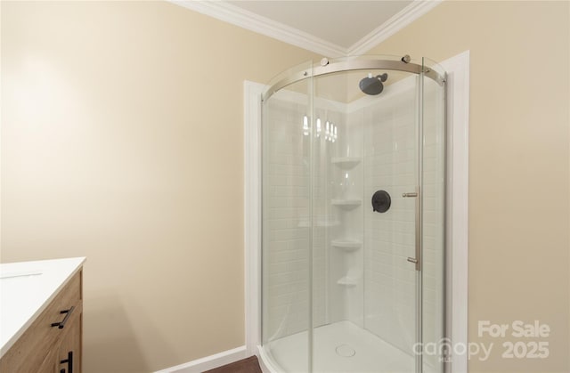 bathroom with ornamental molding, a shower with door, and vanity