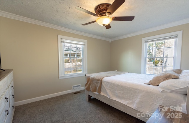 carpeted bedroom with ceiling fan, ornamental molding, and a textured ceiling