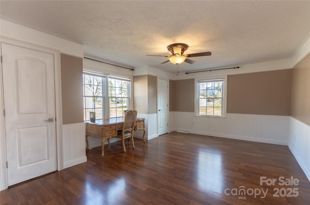 unfurnished office with ceiling fan, dark wood-type flooring, and a textured ceiling