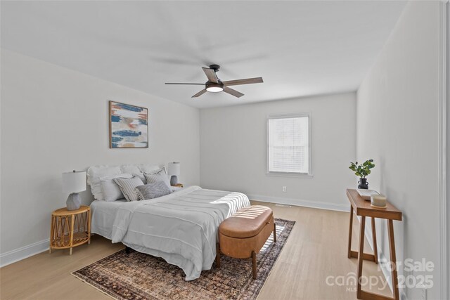 bedroom with ceiling fan and light hardwood / wood-style flooring