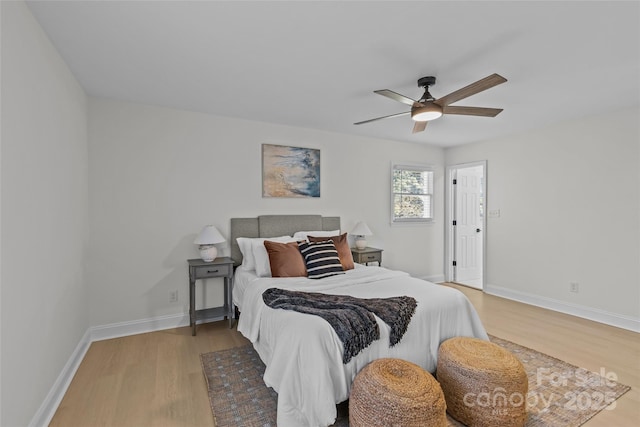 bedroom with light hardwood / wood-style floors and ceiling fan