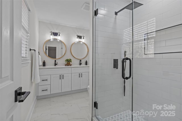 bathroom featuring vanity, a shower with shower door, and toilet