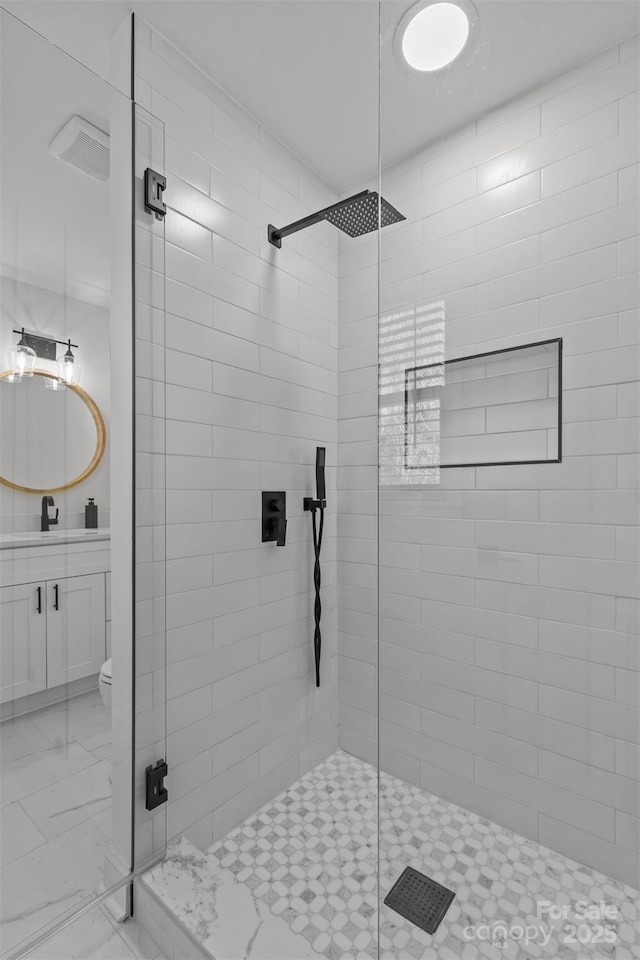 bathroom featuring vanity, toilet, and a shower with door