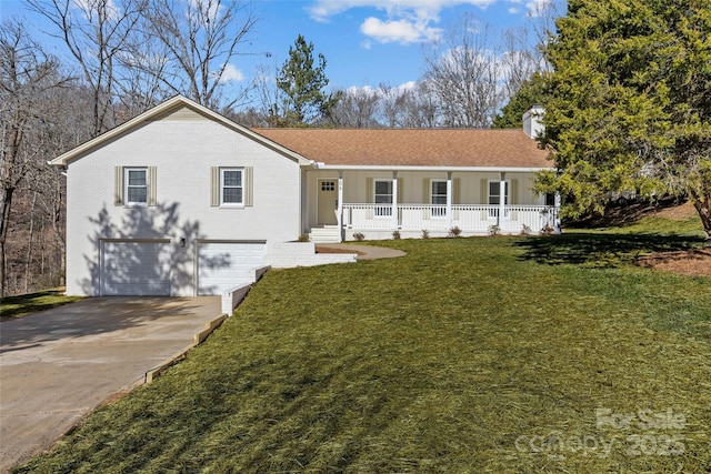 single story home featuring a porch, a garage, and a front yard