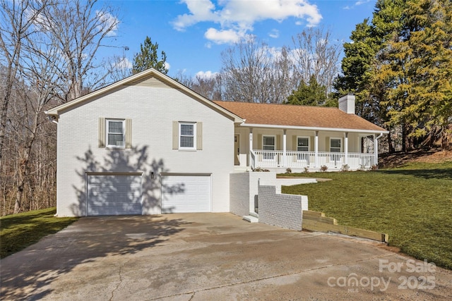 view of property with a porch, a garage, and a front yard