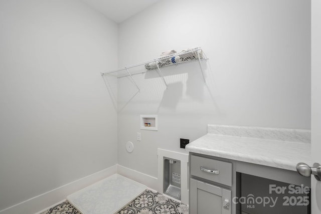 laundry area with cabinets, washer hookup, and tile patterned floors