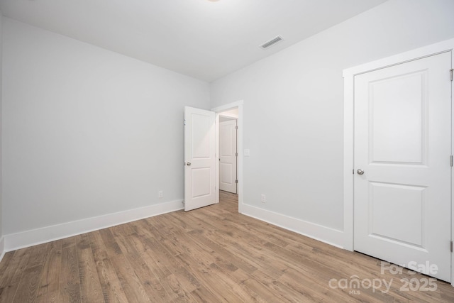 unfurnished bedroom with light wood-type flooring