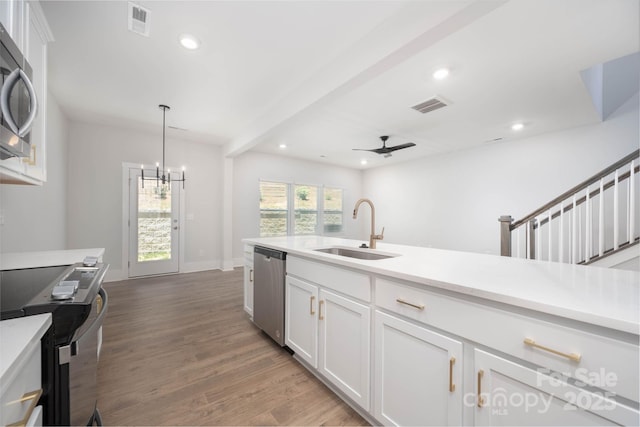 kitchen featuring white cabinetry, stainless steel appliances, dark hardwood / wood-style flooring, and sink