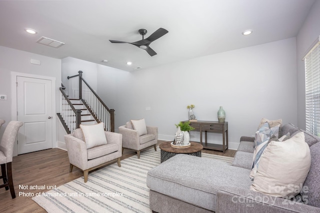 living room featuring hardwood / wood-style flooring and ceiling fan