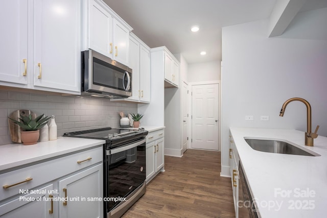 kitchen featuring white cabinetry, appliances with stainless steel finishes, sink, and tasteful backsplash