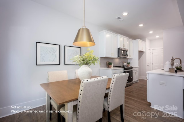 dining space featuring dark hardwood / wood-style flooring