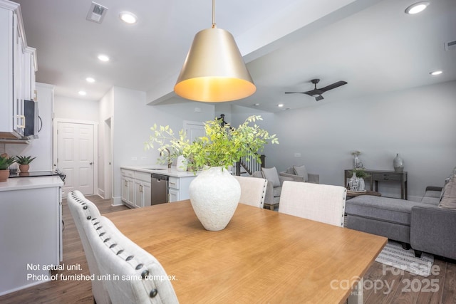 dining space with ceiling fan, light hardwood / wood-style floors, and sink