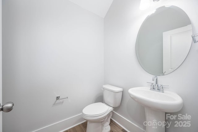 bathroom with wood-type flooring and toilet