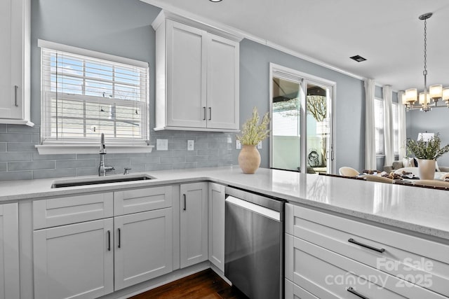 kitchen with a sink, decorative backsplash, dishwasher, and a wealth of natural light