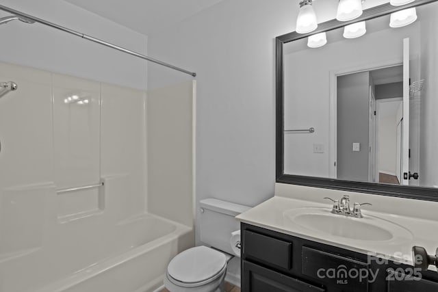 bathroom featuring vanity, toilet, and washtub / shower combination