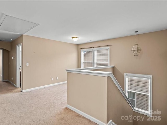 hallway featuring light colored carpet