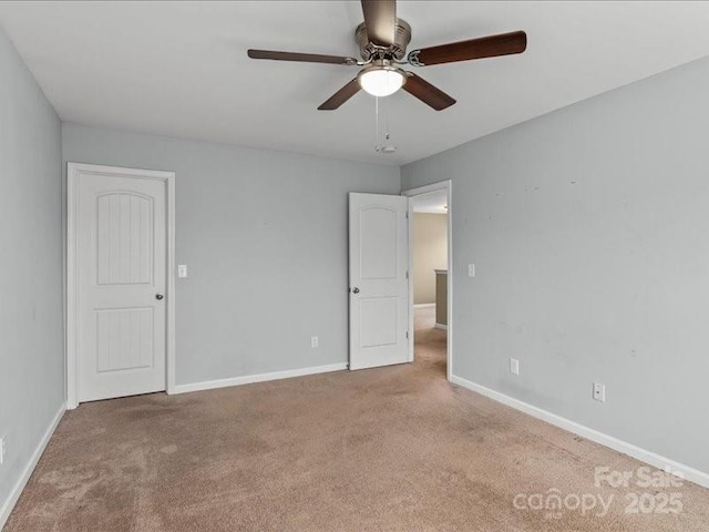 carpeted spare room with ceiling fan