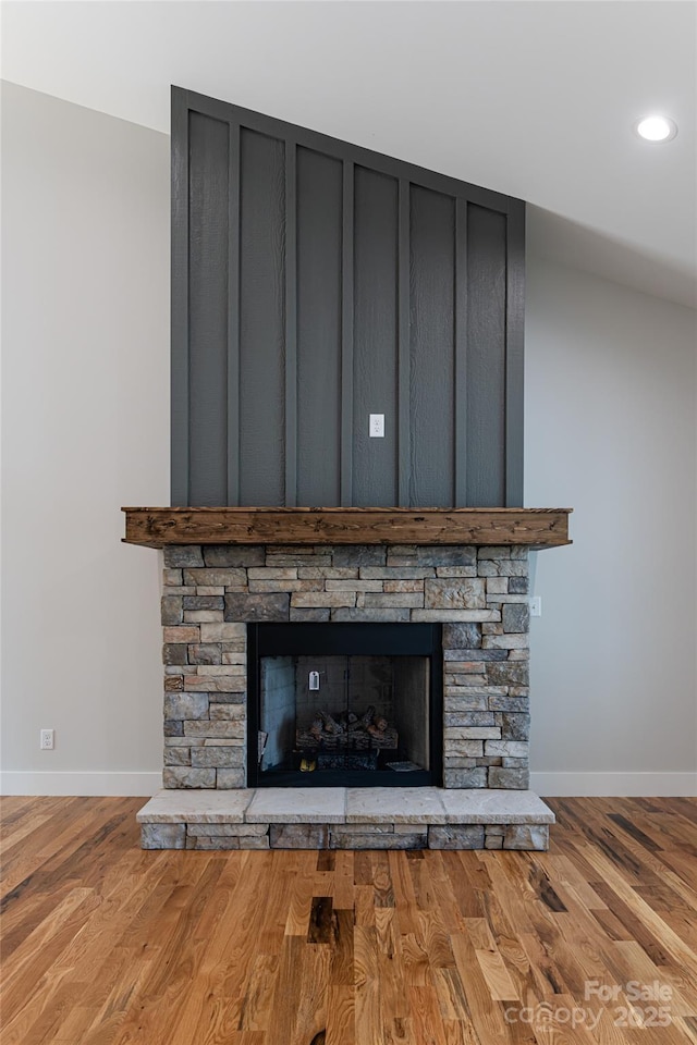 details with a stone fireplace, recessed lighting, baseboards, and wood finished floors