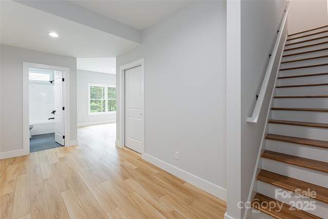 stairs featuring recessed lighting, wood finished floors, and baseboards