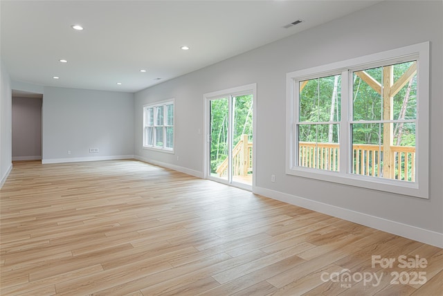 empty room featuring recessed lighting, visible vents, baseboards, and light wood-style floors