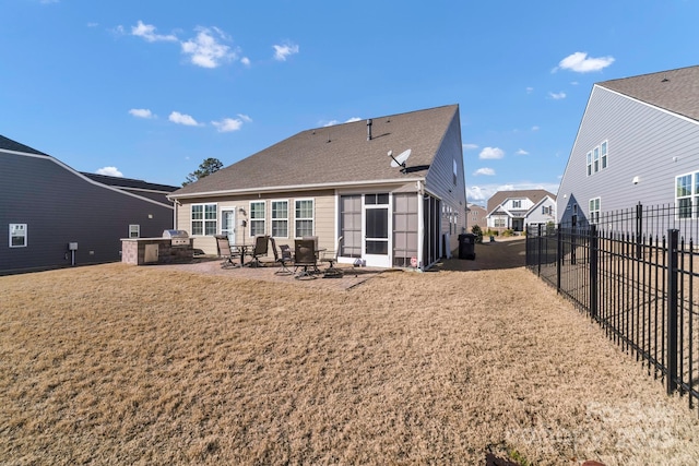 rear view of house with a patio and a lawn