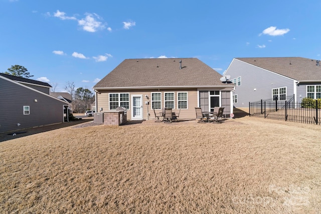 rear view of house featuring a yard and a patio area