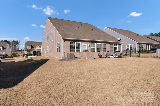 back of property featuring a lawn, a patio area, and central air condition unit