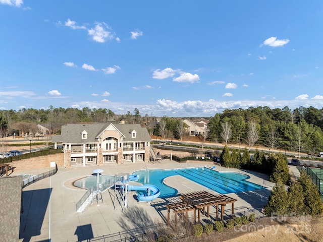 view of swimming pool with a patio and a water slide