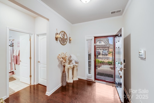 foyer with wood-type flooring and ornamental molding