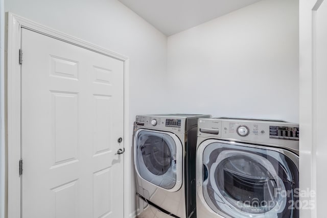 clothes washing area with washer and dryer