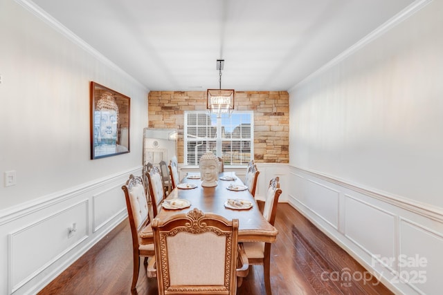 dining area featuring crown molding and dark hardwood / wood-style flooring