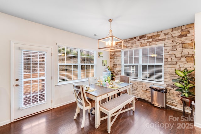 dining room featuring an inviting chandelier and dark hardwood / wood-style flooring