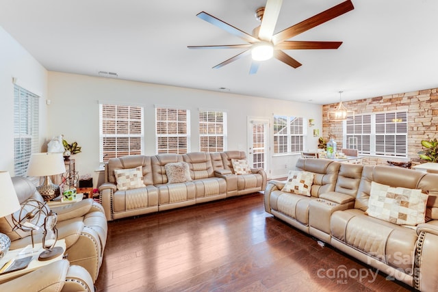 living room with dark wood-type flooring and ceiling fan