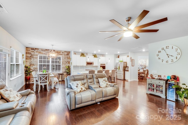 living room featuring wood-type flooring and ceiling fan