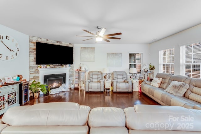 living room with wine cooler, ceiling fan, dark hardwood / wood-style floors, and a stone fireplace