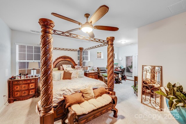 bedroom featuring ceiling fan, carpet, and ornate columns