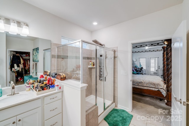 bathroom featuring an enclosed shower, vanity, and tile patterned flooring