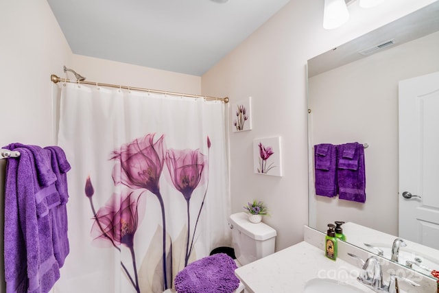 bathroom featuring vanity and toilet