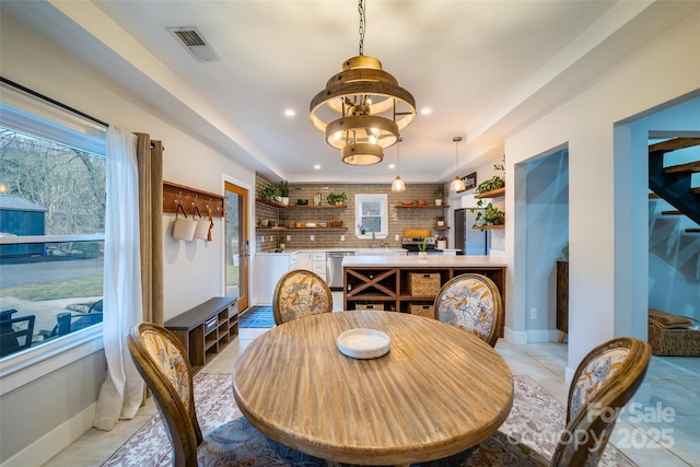 dining room with an inviting chandelier and light tile patterned floors