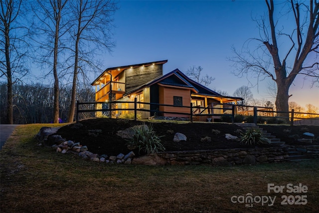 view of back house at dusk