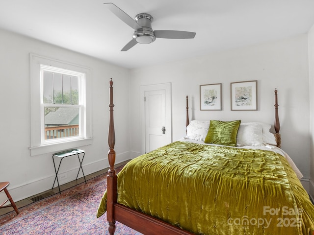 bedroom with baseboards, wood finished floors, and ceiling fan