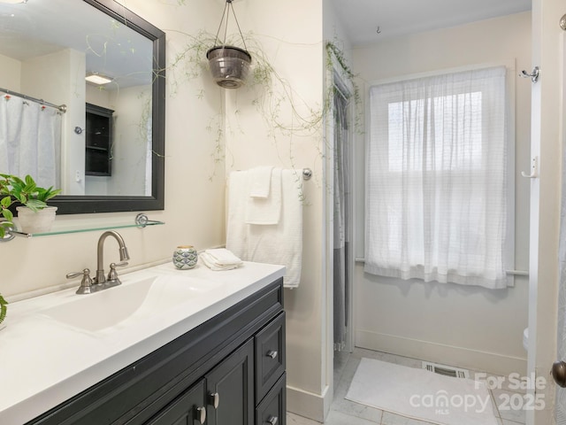 full bath featuring baseboards, visible vents, and vanity
