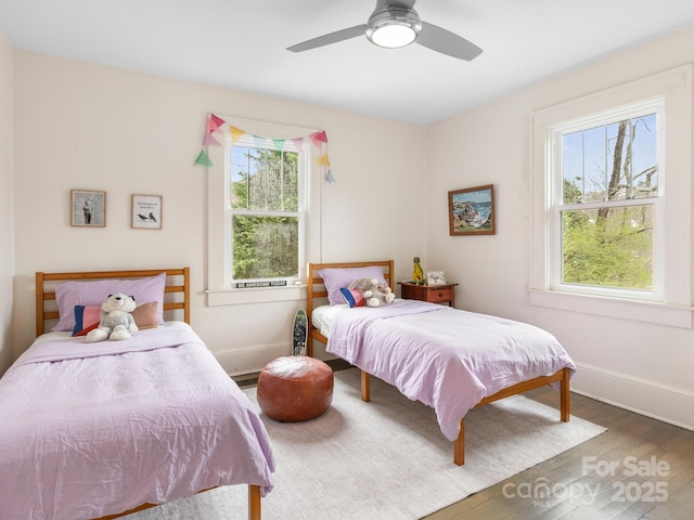 bedroom with baseboards, ceiling fan, and wood finished floors