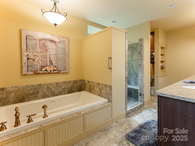 bathroom with vanity and independent shower and bath