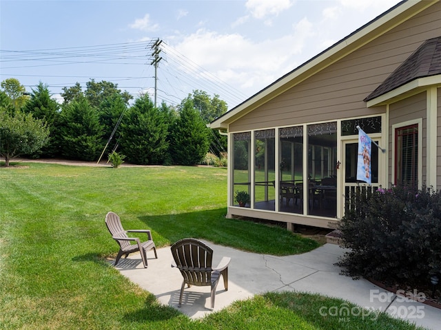 view of yard featuring a patio area and a sunroom