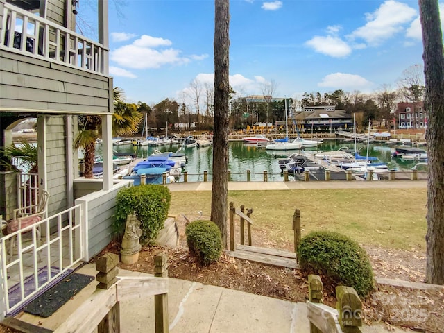 view of yard featuring a dock and a water view