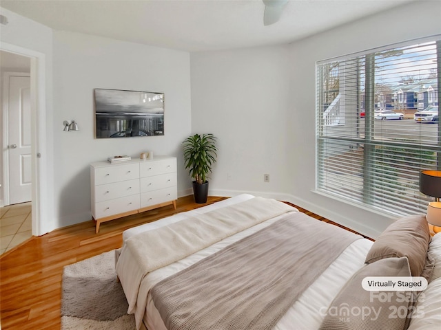 bedroom with ceiling fan and light hardwood / wood-style flooring