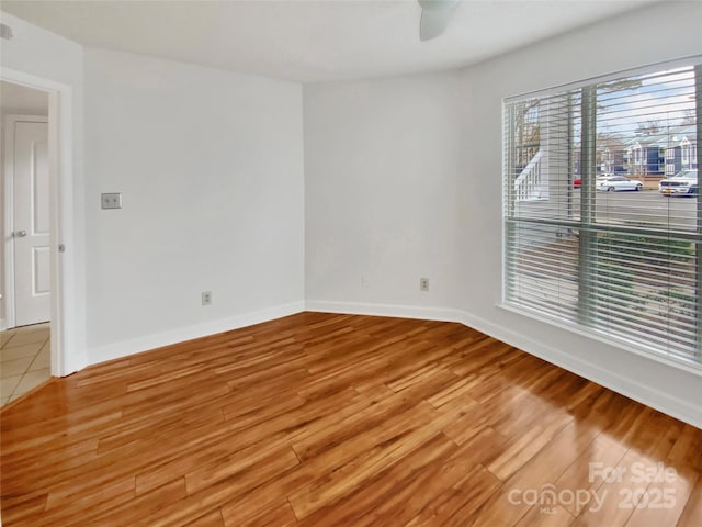 spare room with hardwood / wood-style flooring and ceiling fan