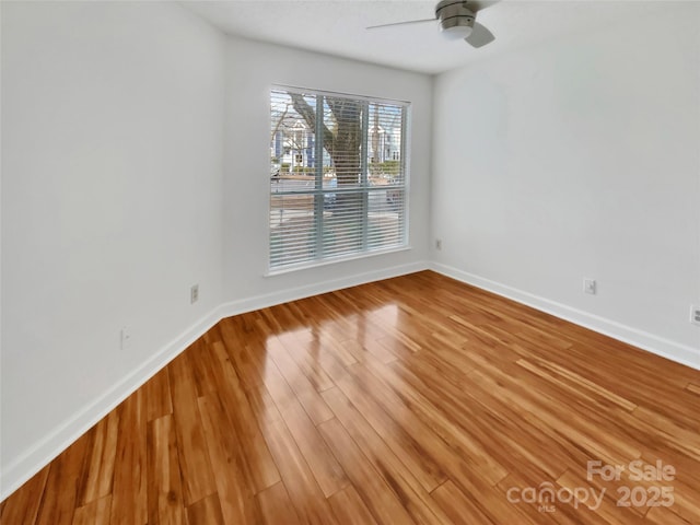 unfurnished room with wood-type flooring and ceiling fan